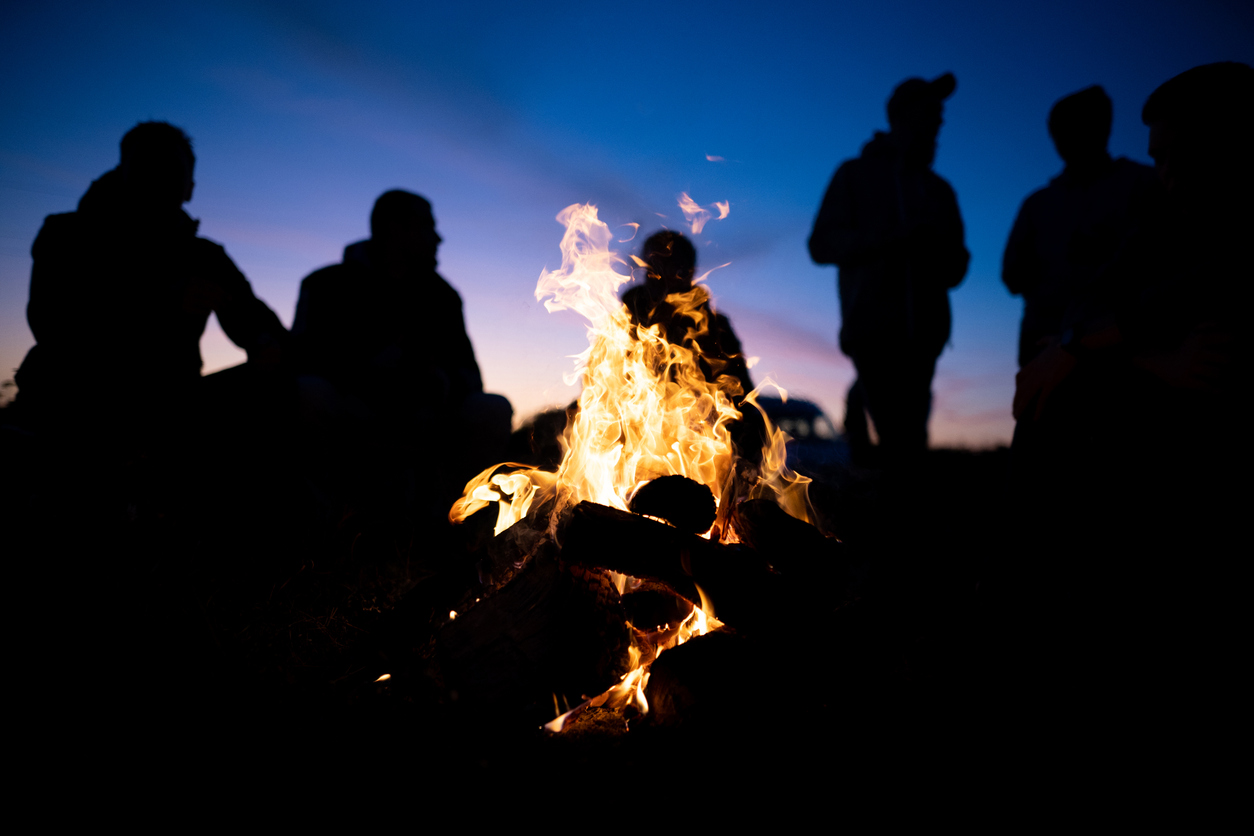 A-group-of-friends-gathered-around-the-fire-at-night