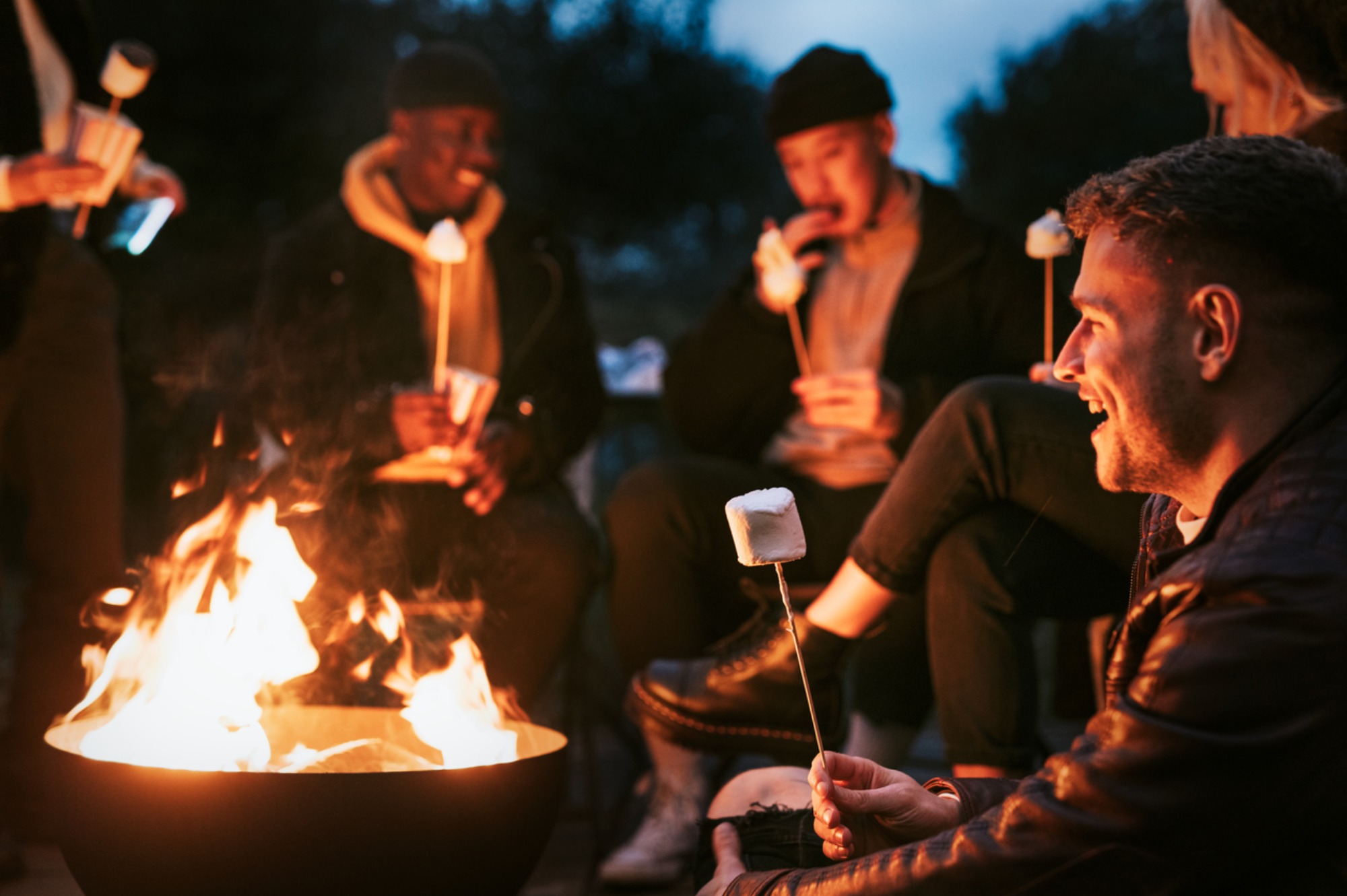 Friends-enjoying-marshmallow-together-by-the-bonfire