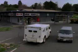 An armored are stopped in the parking lot of a gas station