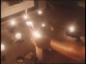 Woman lighting various candles for a seance