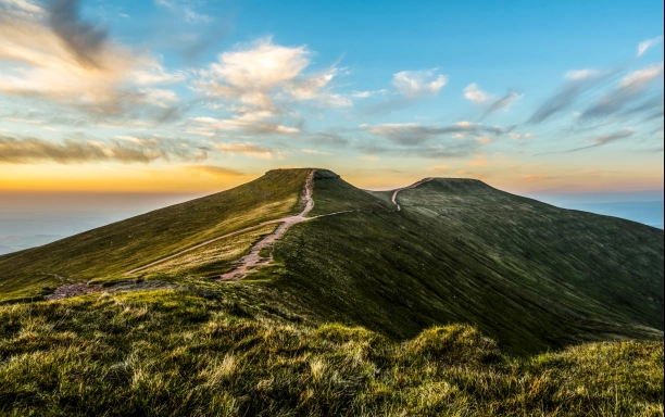 header footpaths along hills with cloudy blue sunset sky background climbing pen y fan credit jonathan wakelin istock