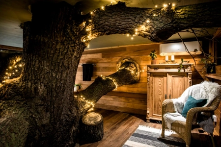treehouse living with tree with fairy lights growing through it top ten treehouses credit coolstays